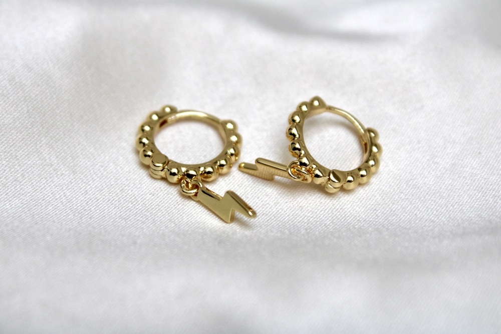 Close Up Of A Pair Of Golden Earrings In A