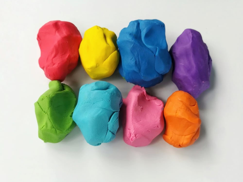 Colorful Clay Plasticine Placed On White Background