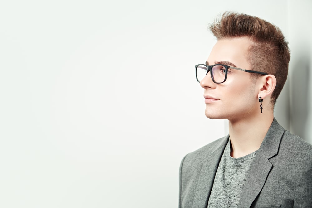 a man wearing a earring and glasses