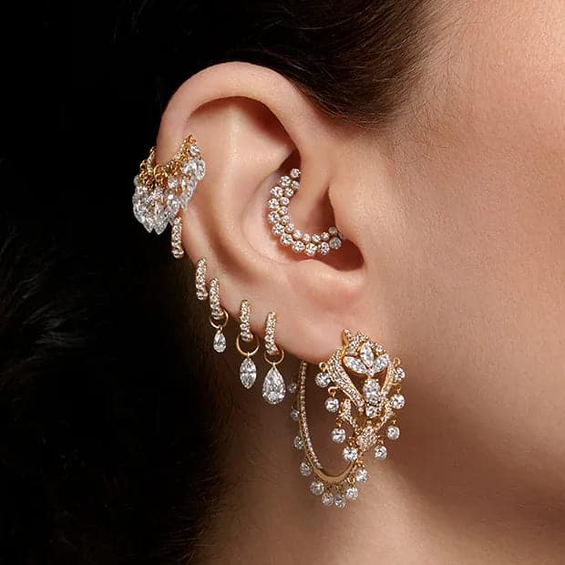 a lady adorning her ear with Artistic Custom Cartilage Jewelry