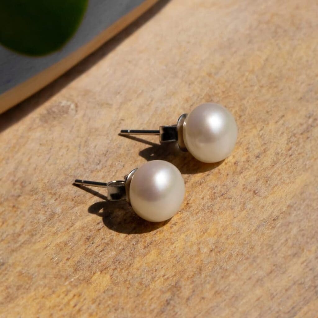 Pearl Stud Earrings pair placed on the floor