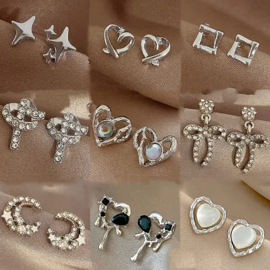 a variety of silver stud earrings placed in front of a golden background