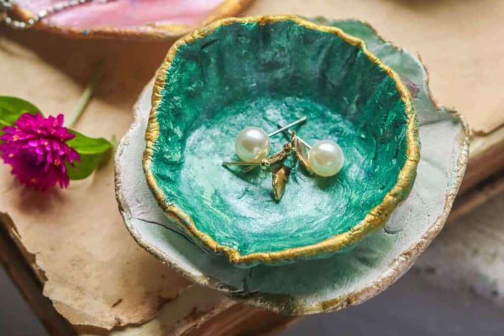 earrings organized in a marble green tray