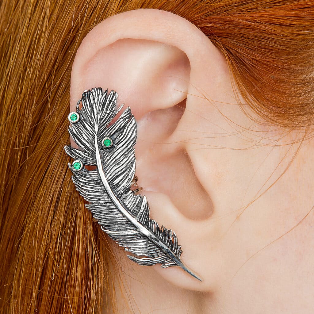 a large feather ear cuff in an ear 