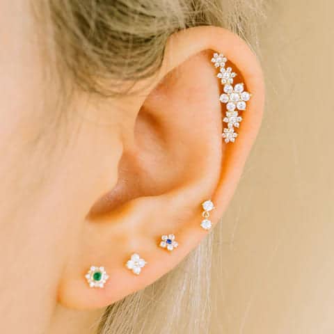  a lady wearing stylish flat back cartilage earrings in an ear