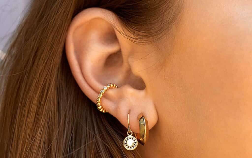 an ear showing the styling styling of earrings and ear cuffs