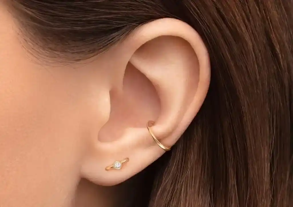 Orbital Piercing with a golden hoop in it