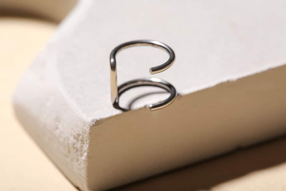 Plaster Podium With Ear Cuff Ring On Beige Background