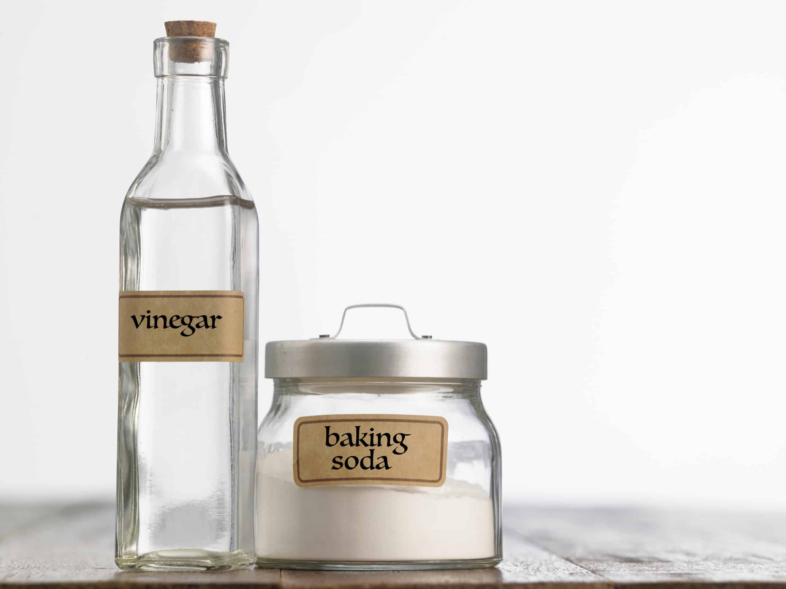 Close Up Of Baking Soda And Vinegar On Table Against White Background