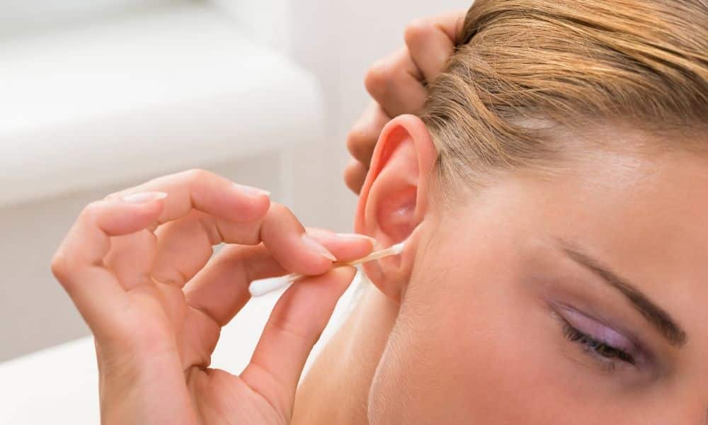 a lady cleaning her ear