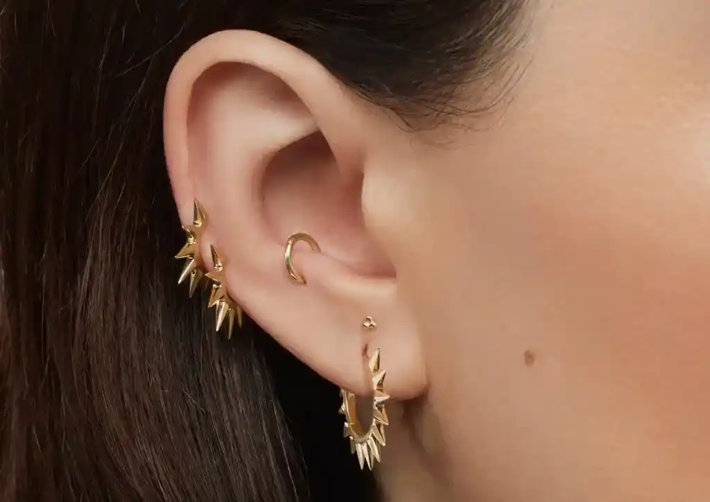 anti tragus piercing with a golden hoop