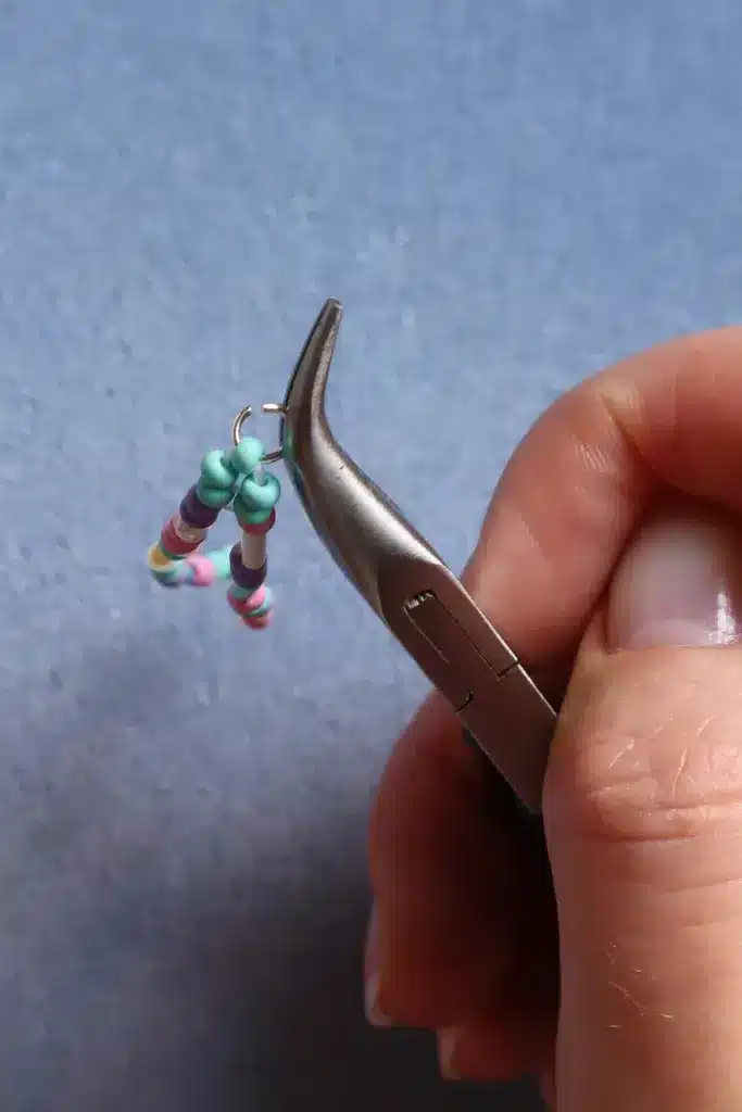 securing th beads on thread with a nose plier