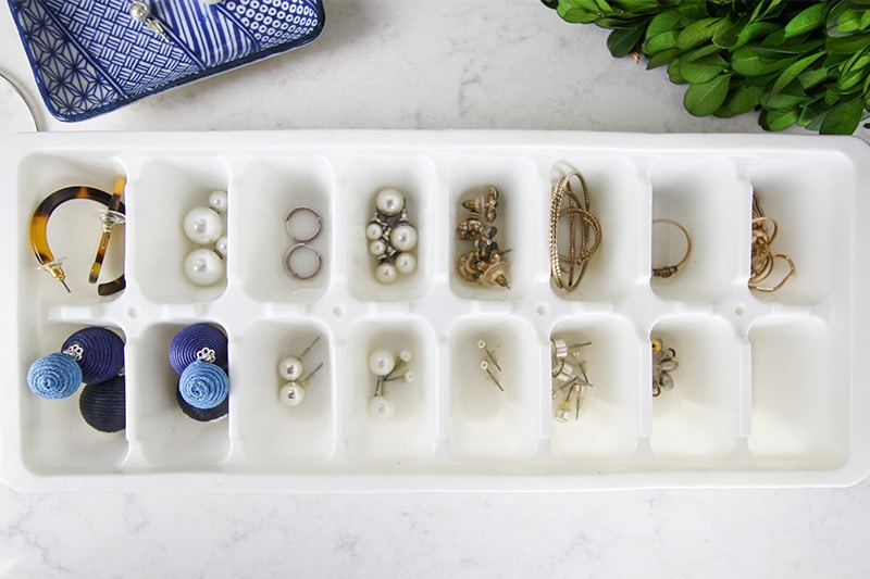 earrings organized in a ice cube tray