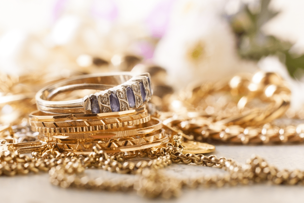 shiny gold and silver jewelery on white table