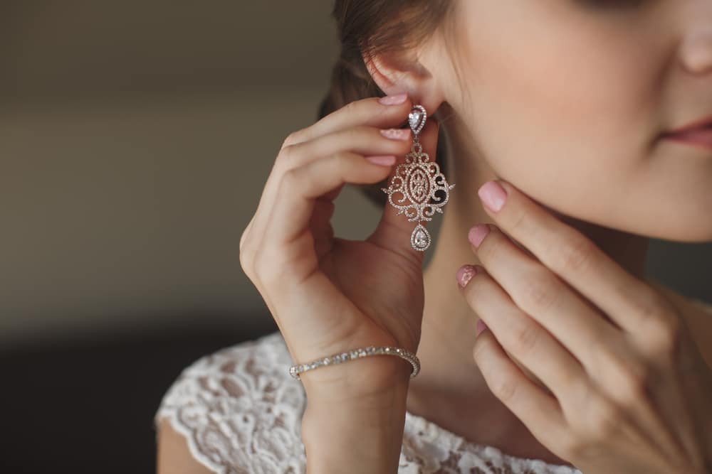 Wedding Earrings On A Female Hand 