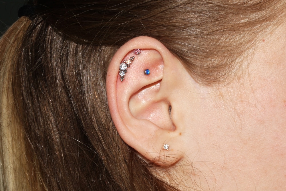 Girl's Ear With Three Ear Cartilage Piercings And One Lobe