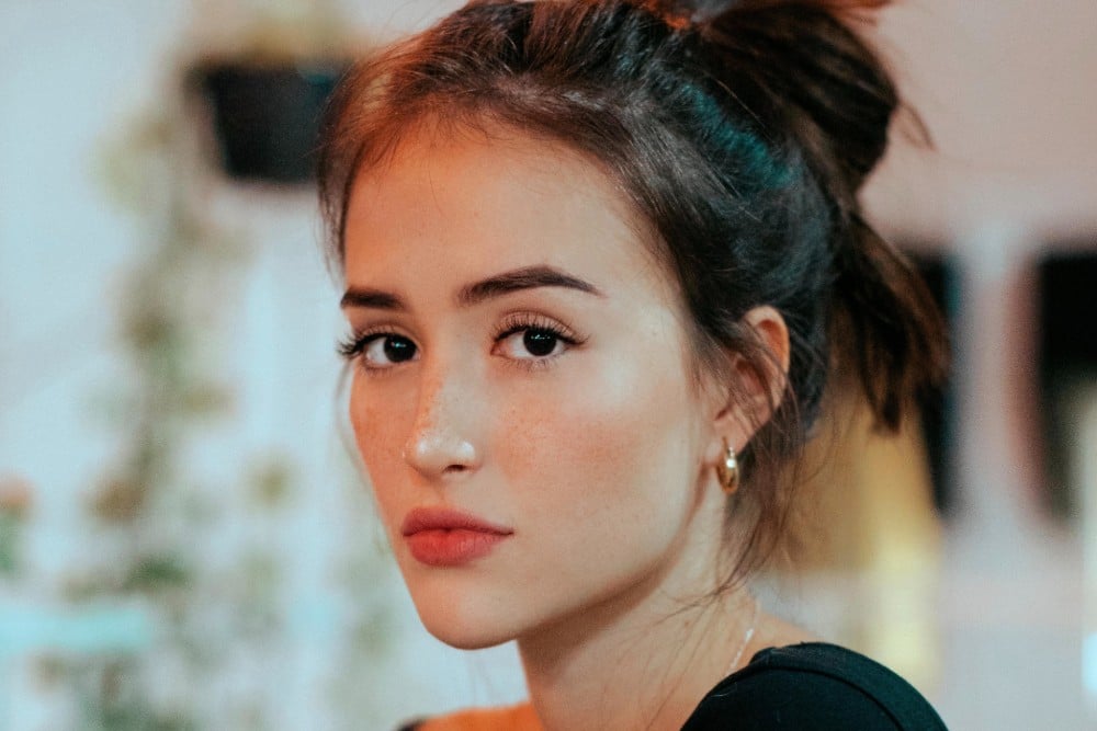 a looking posing for camera with cute earrings on a looking posing for camera with cute earrings on