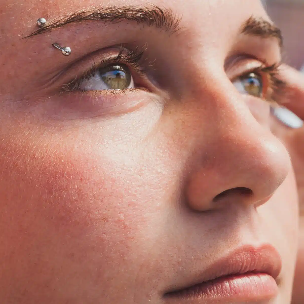 close up of a beautiful girl with eyebrow piercing