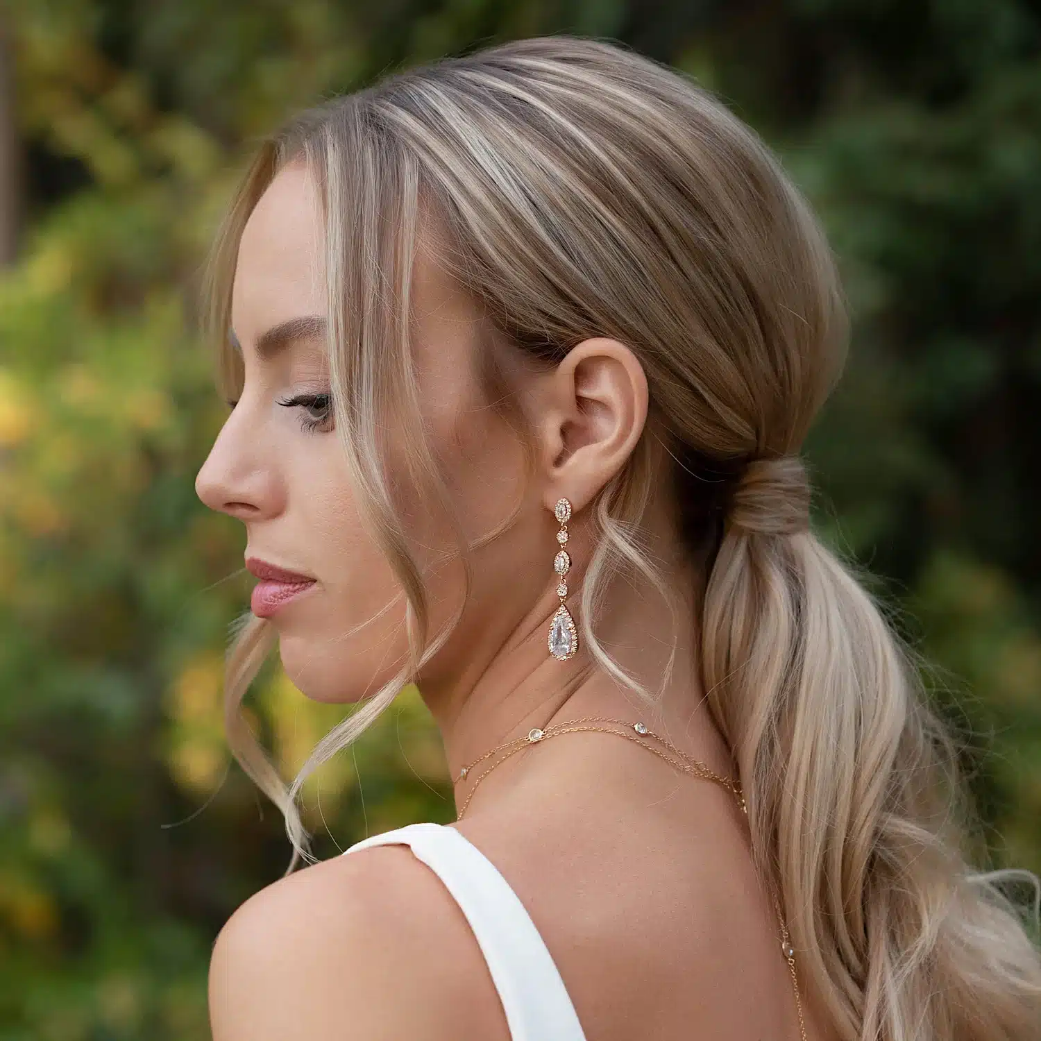 side pose of a girl with blonde hair wearing drop earrings side pose of a girl with blonde hair wearing drop earrings