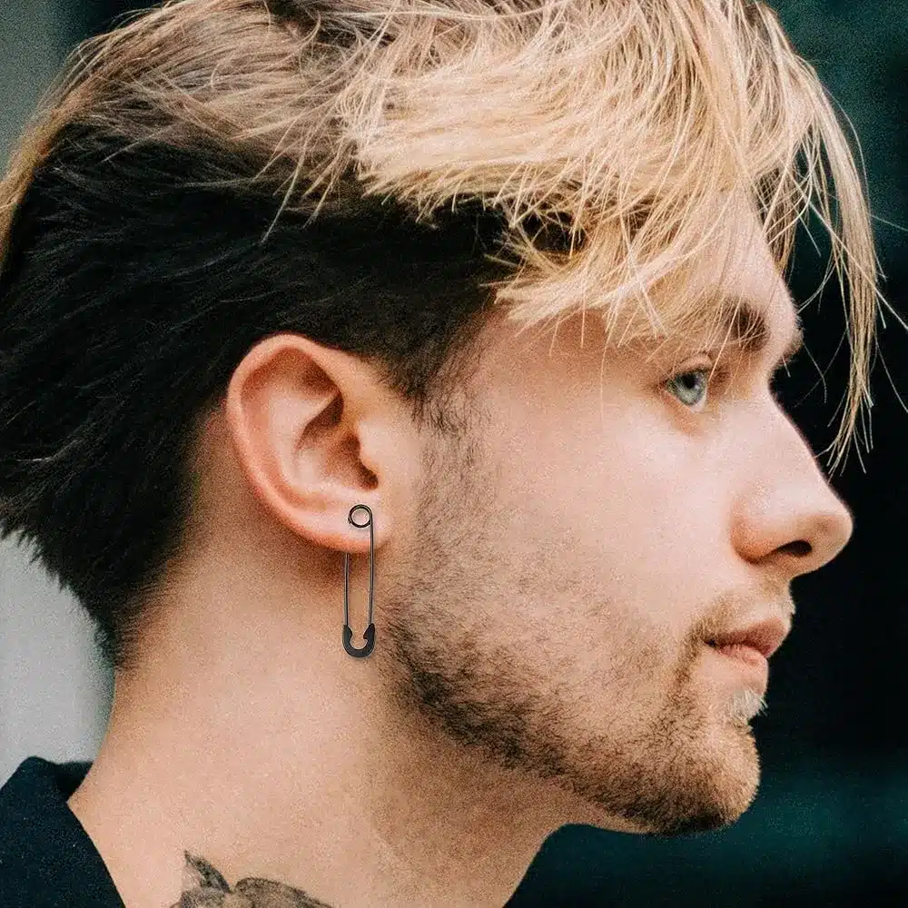a boy styling a safety pin earring