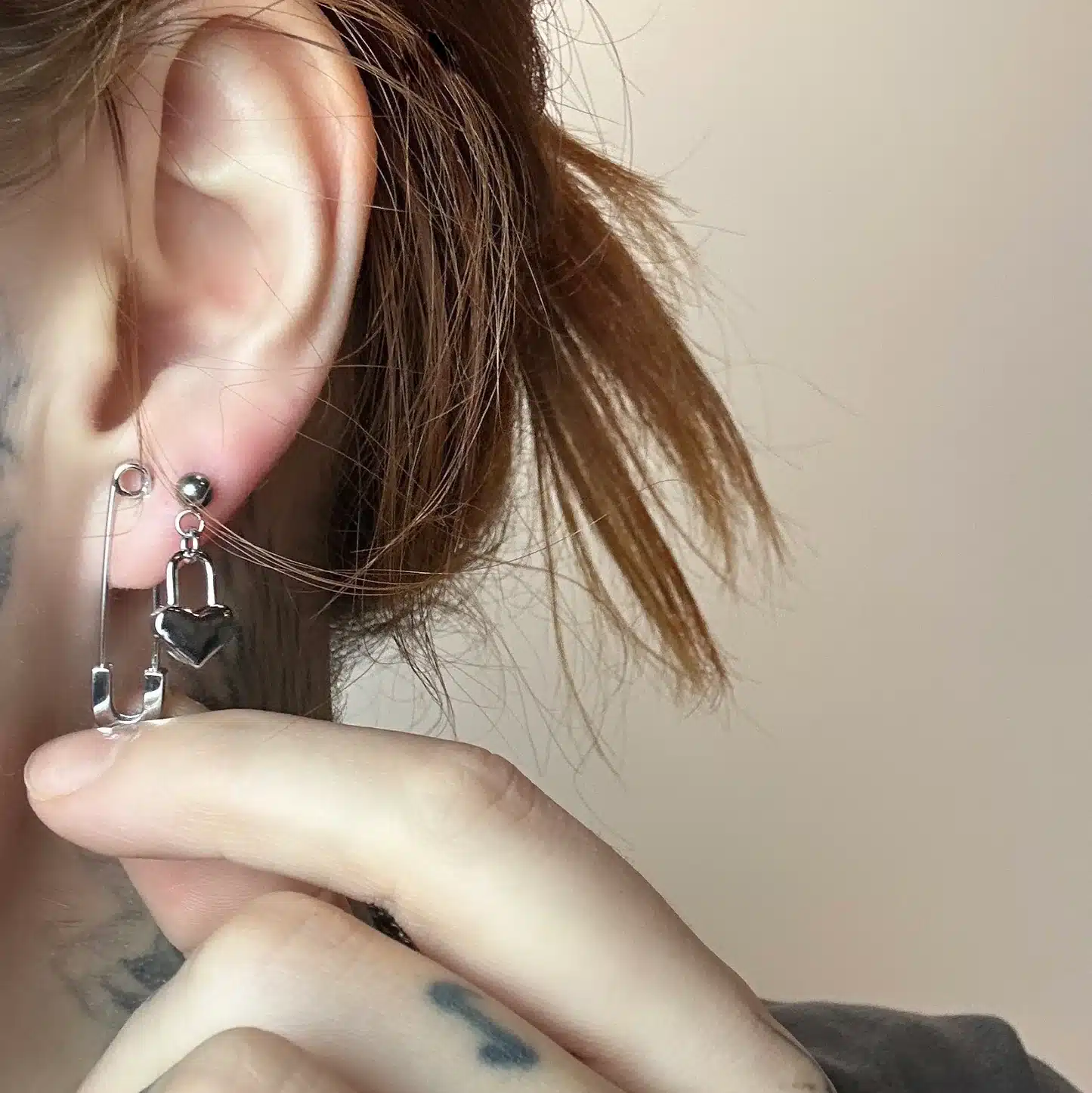 close up of an ear styling safety pin earring