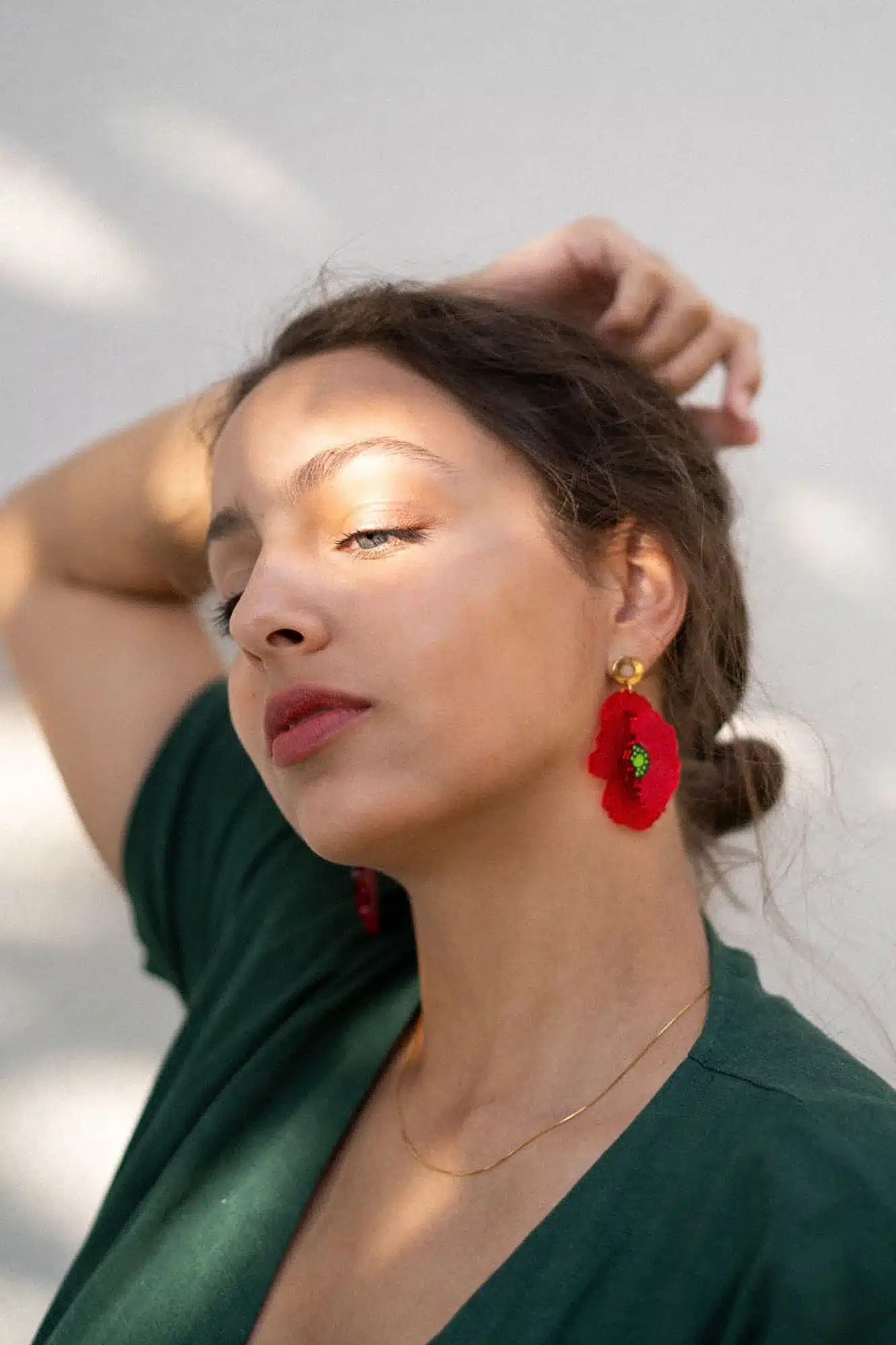 a girl posing for camera wearing red earrings