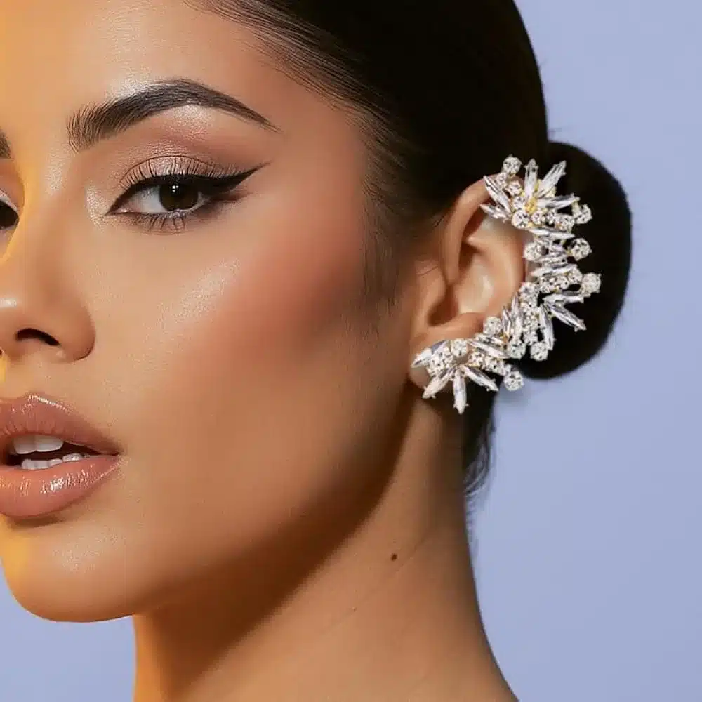 a girl posing for the camera wearing fancy ear cuffs