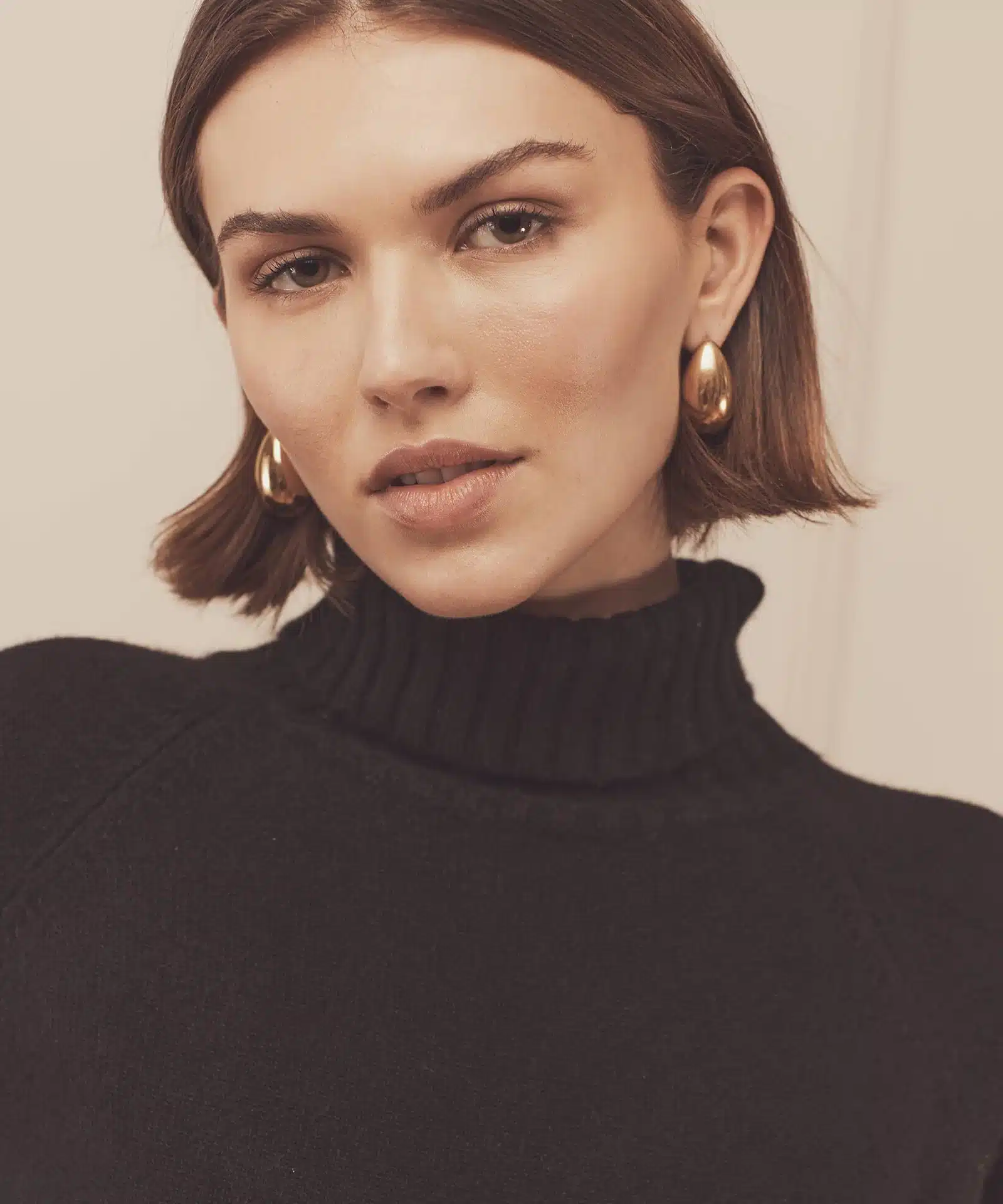 a girl with bob cut wearing studs