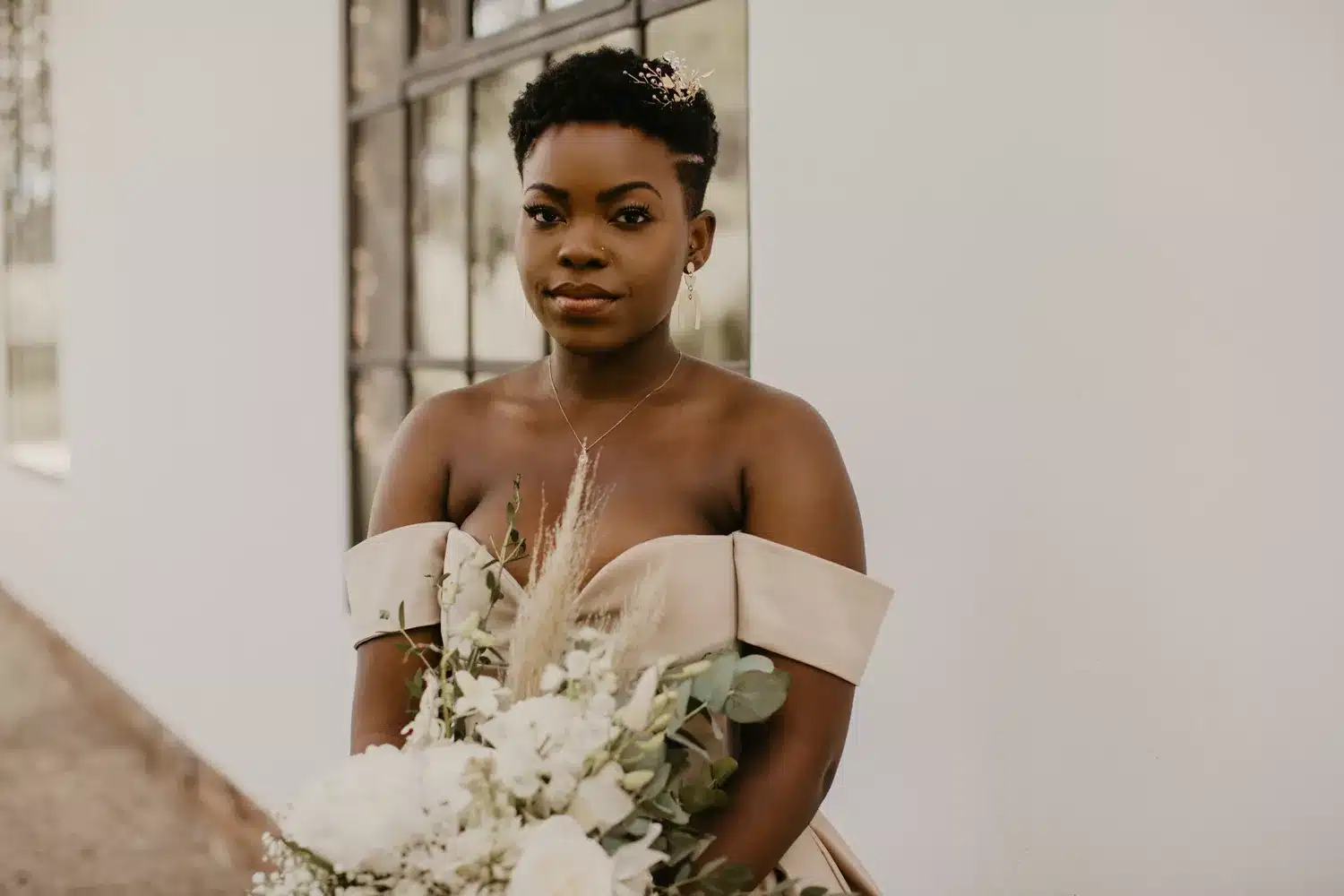 an asian bride with pixie haircut carrying a bouquet an asian bride with pixie haircut carrying a bouquet